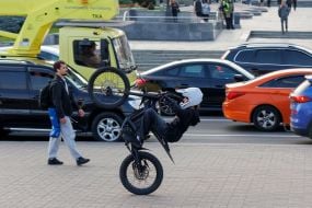 A guy is performing stunts on a motorcycle.