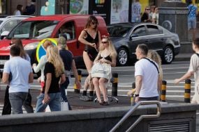 A hairdresser styles a young woman's hair in the center of Kyiv