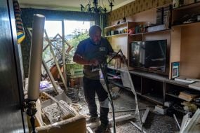 A man in a damaged apartment