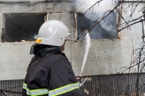 A rescuer extinguishes a fire