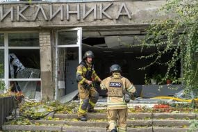 Rescuers near a damaged medical facility