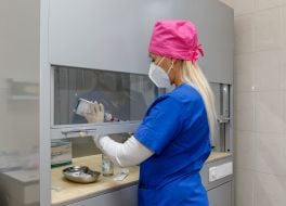 A laboratory technician prepares solutions for IV drips