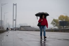 People are crossing the Pivdeny Bridge on foot