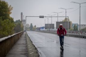 People are crossing the Pivdeny Bridge on foot