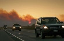 Alaska wildfires destroy dozens of homes, menace highway