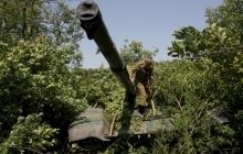 LPR militants simulate tanks withdrawal, masking them in forests