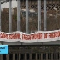 Femen activist hangs from Paris bridge in anti-Rouhani protest
