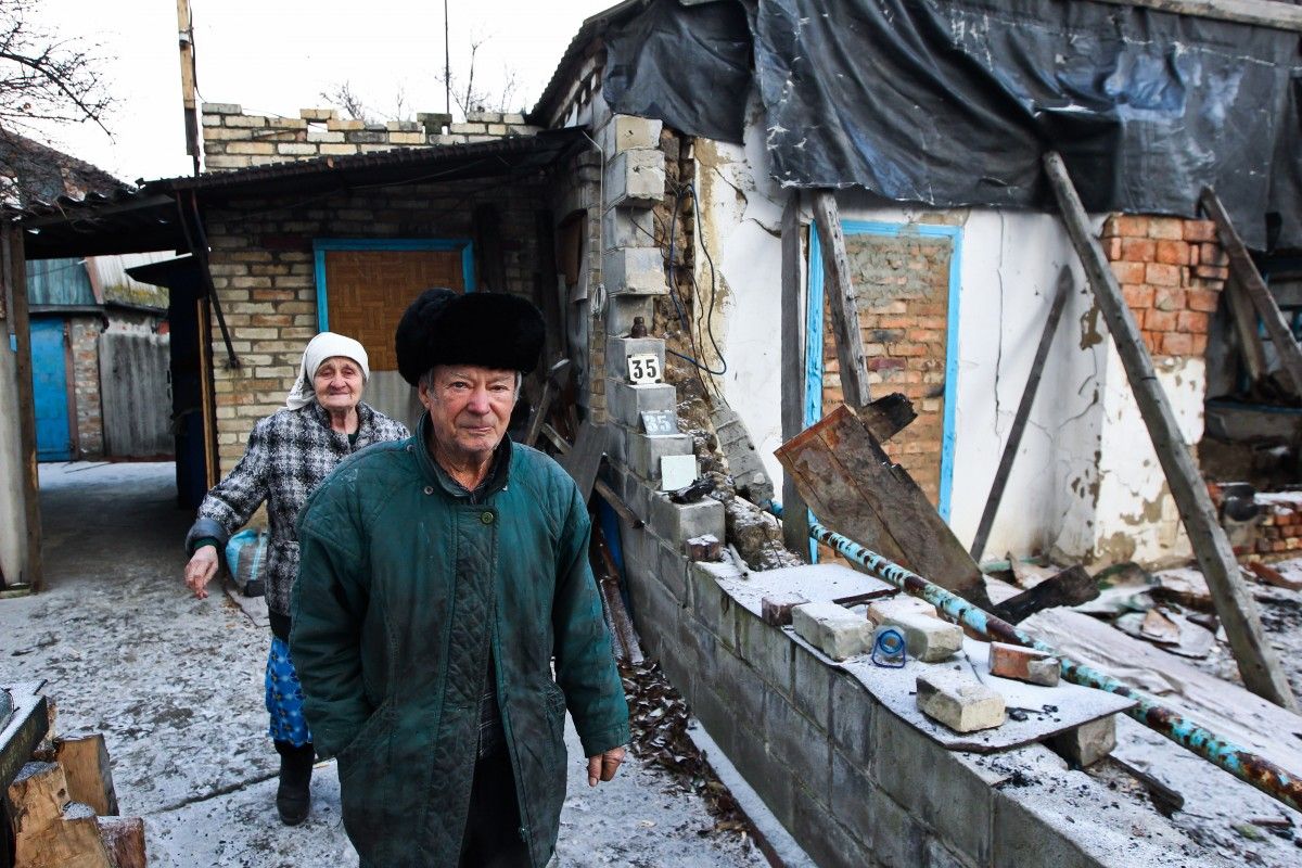 An elderly couple - Maria and Mykola – saw half of their house demolished in a shelling / Photo from UNIAN