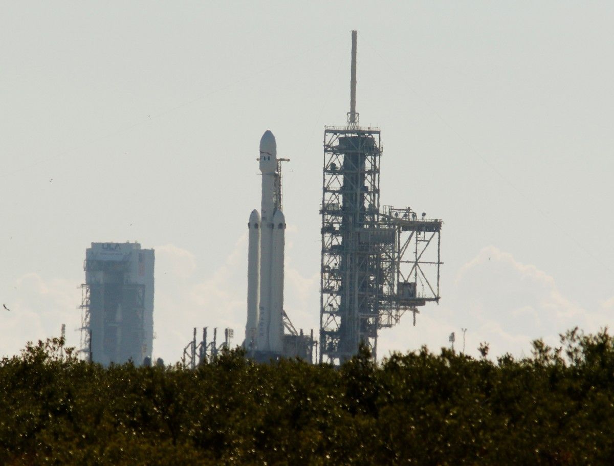 Ракета-носитель Falcon Heavy на стартовой площадке ждет первое испытание двигателей / REUTERS Ракета-носитель Falcon Heavy на стартовой площадке ждет первое испытание двигателей / REUTERS
