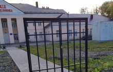 Щодня на замок: в РФ на вході в поліклініку поставили ворота без паркану (фото)