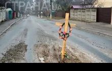 Під Києвом у величезну дорожню яму встановили хрест із вінком (фото)