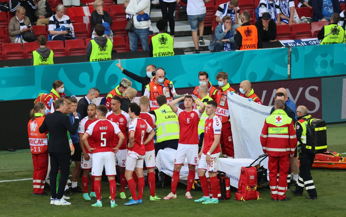 The players of the Danish national team surrounded the football player / REUTERS