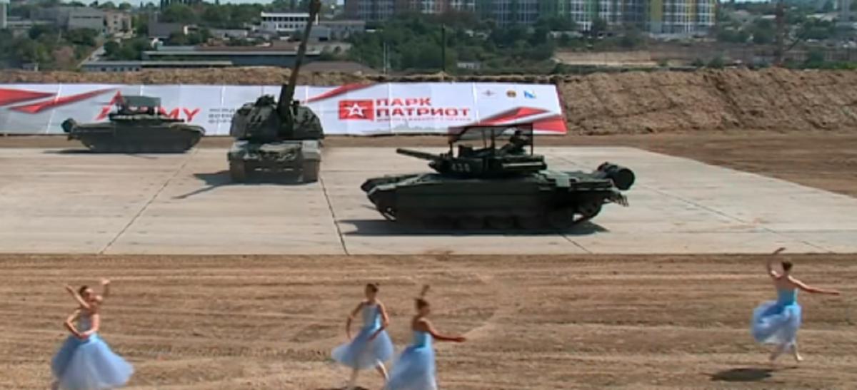 Впереди техники танцевала группа женщин в платьях / Скриншот Впереди техники танцевала группа женщин в платьях / Скриншот
