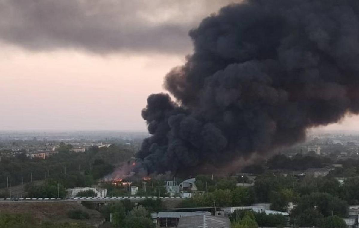 A large column of dark smoke rose over the village A large column of dark smoke rose over the village